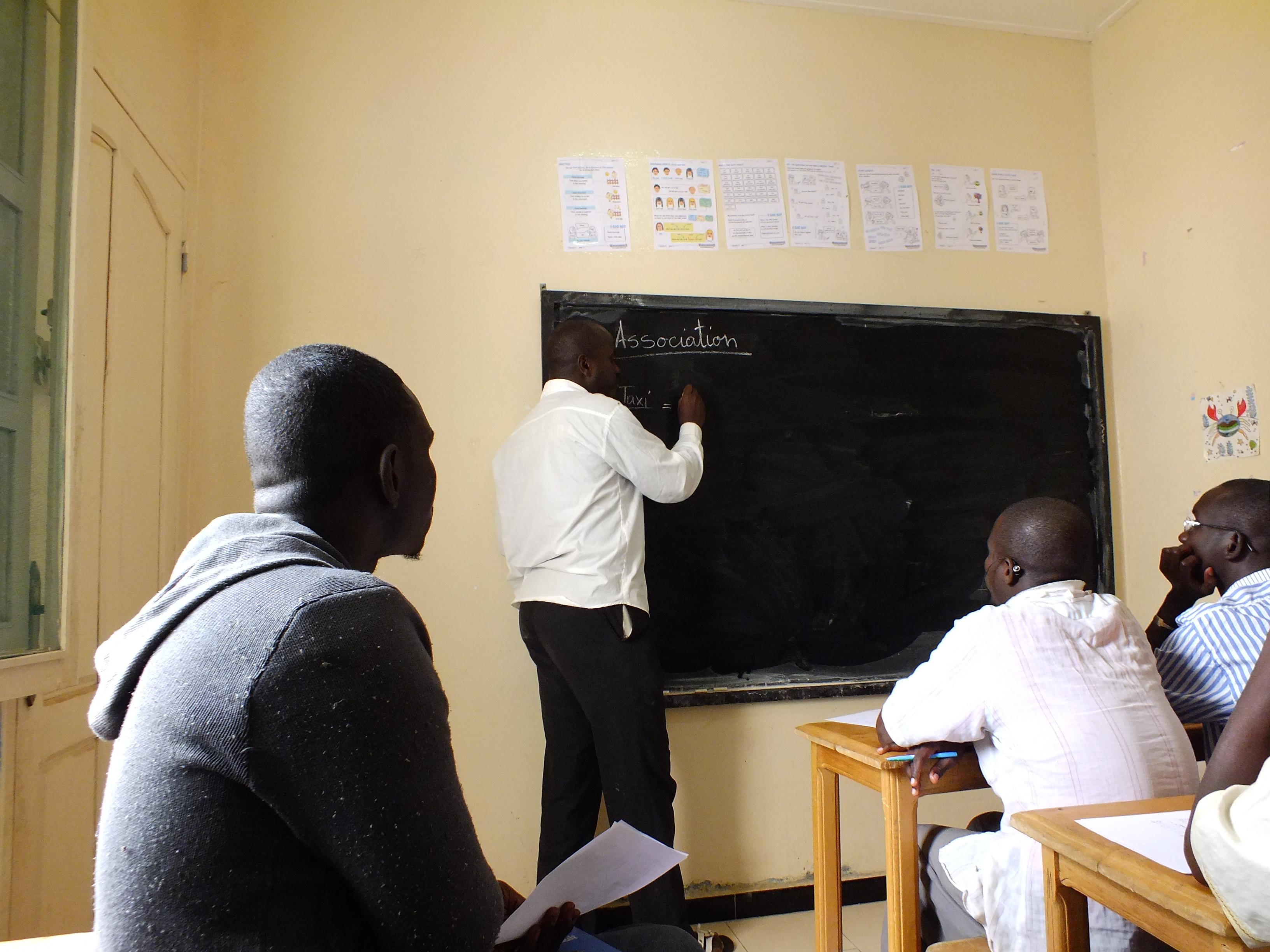 A Projects Abroad volunteer hosts a class in Senegal. A teaching volunteer write on the board during a lesson in Senegal.